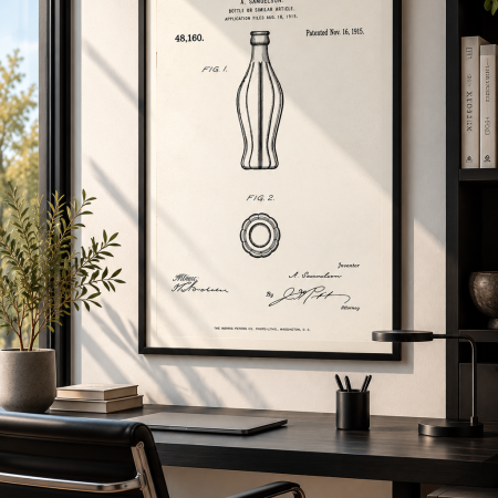 Samuelson 1915 bottle design patent poster in a black frame above a modern office desk.